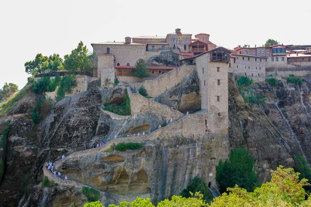 The side view of Great Meteoron Monastery with everything making their way up The side view of Great Meteoron Monastery with everything making their way up