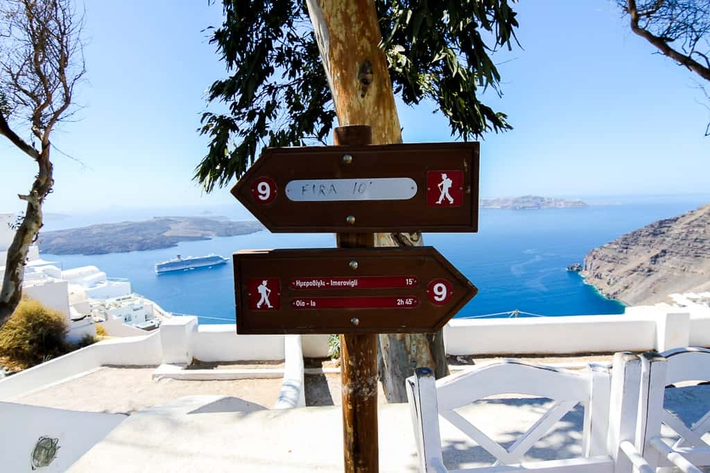 Signs indicating the hike distance between Thira and Oia which is one of the things to do in Santorini