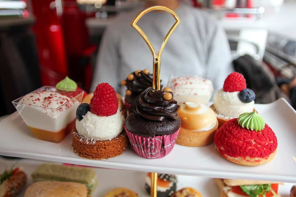 Sweet treats on an afternoon tea bus is one of the food experiences to have in london