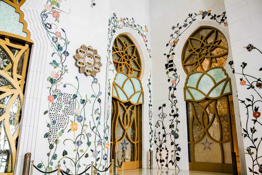 A digital clock displaying prayer times across the world on a beautifully detailed marble wall A digital clock displaying prayer times across the world on a beautifully detailed marble wall