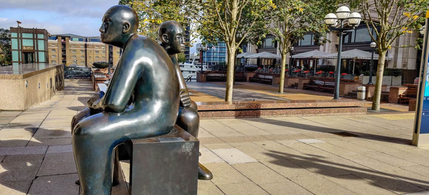 Two men on a bench statue