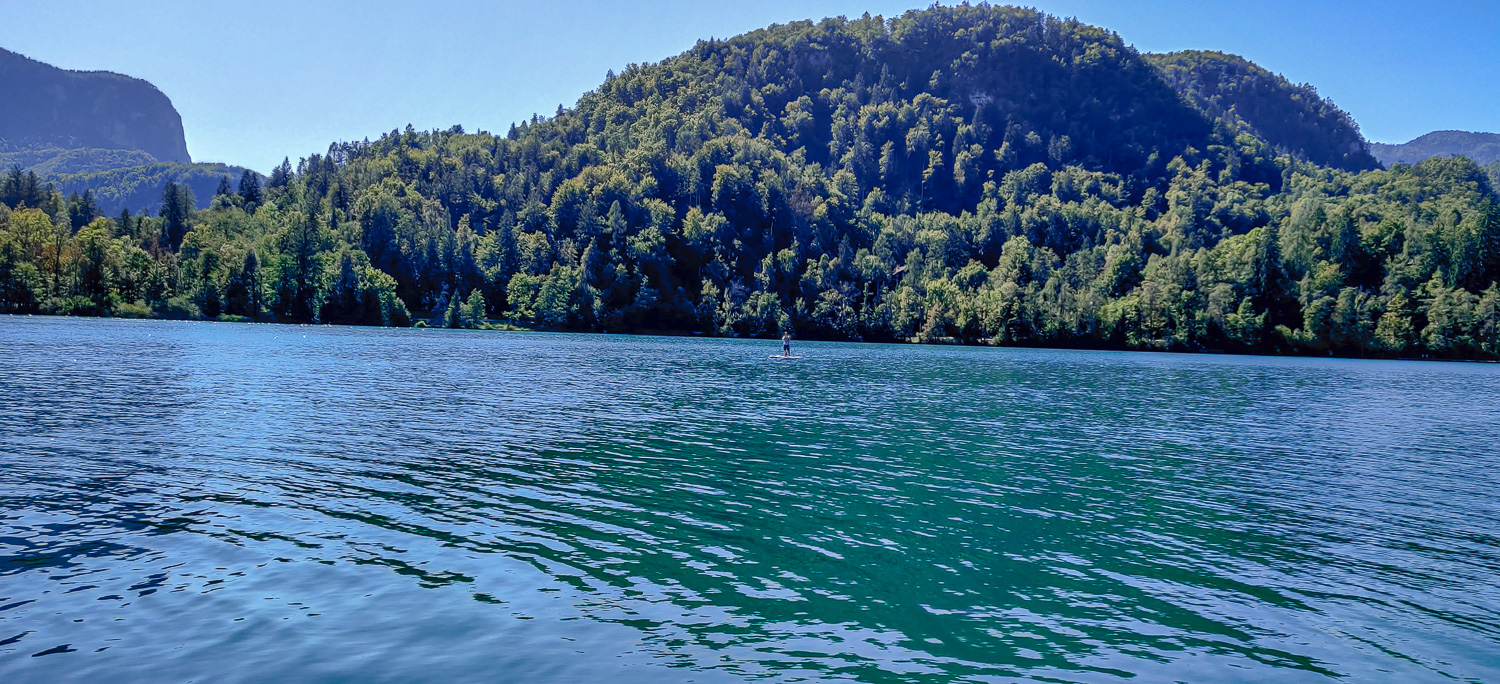 A person stand up paddling on Lake Bled